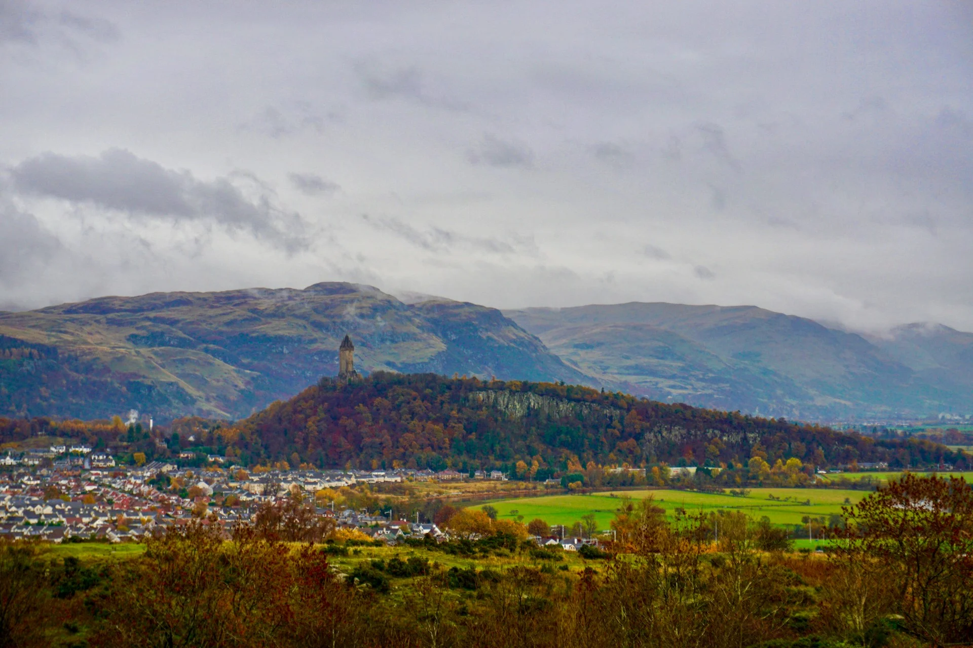 The Wallace Monument above Stirling with the Ochil Hills behind it in autumn